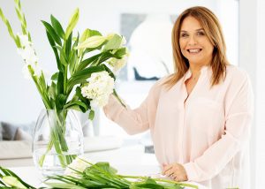 Lifestyle image of woman flower arranging