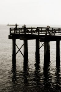 Black and white photograph of fishermen at the end of Coney Island pier in Brooklyn
