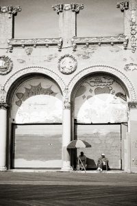 Two old gentlemen sitting outside the Roller Rink in Brooklyn's Coney Island resort