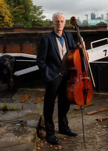 Cellist Stephen Threlfall photographed in Manchester with his cello