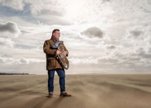 Euphoium player Gary Curtin photographed on Hoylake Beach.