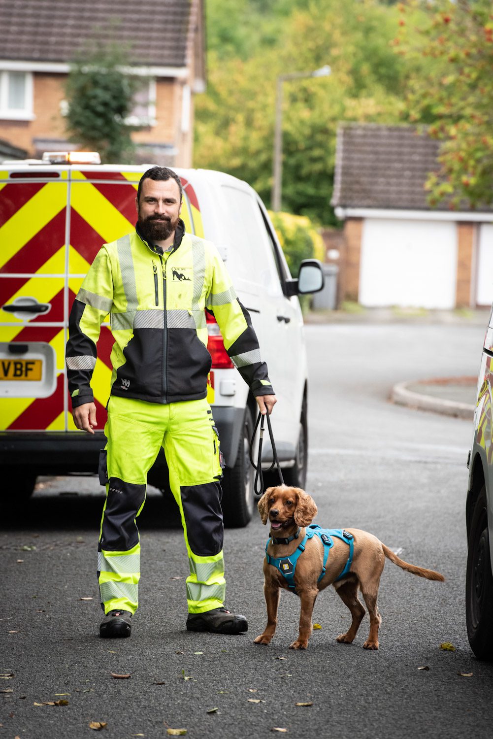 dog and handler in front of van